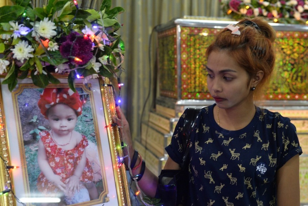 Jiranuch Trirat, mother of 11-month-old daughter who was killed by her father who broadcast the murder on Facebook, stands next to a picture of her daughter at a temple in Phuket, Thailand April 25, 2017. — Reuters pic.