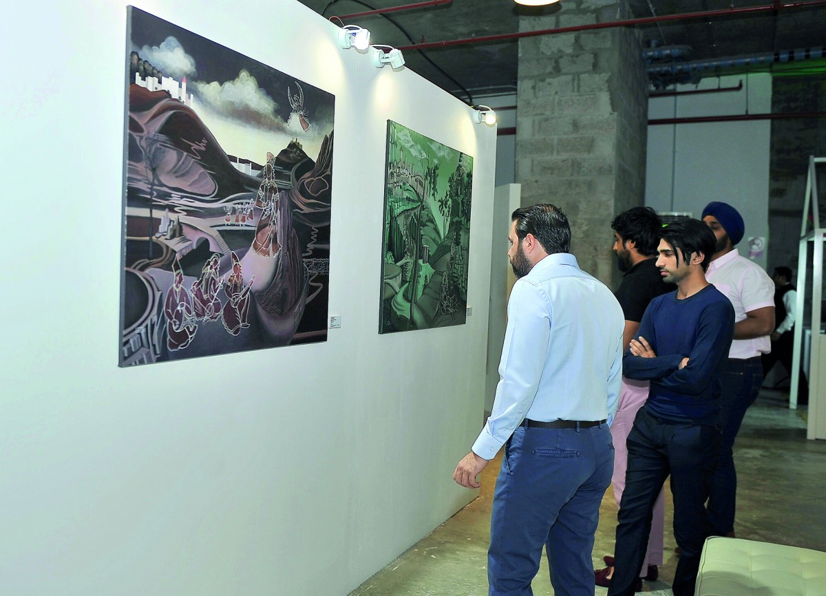Visitors looking at the art works at the Currents exhibition.