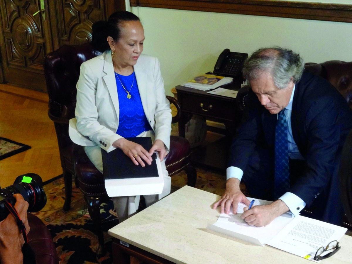 Carmen Velasquez (left), Interim Ambassador of Venezuela at the Organisation of American States, submits a letter to OAS Secretary-General Luis Almagro, formally starting the process to quit the 34-member-countries regional body.