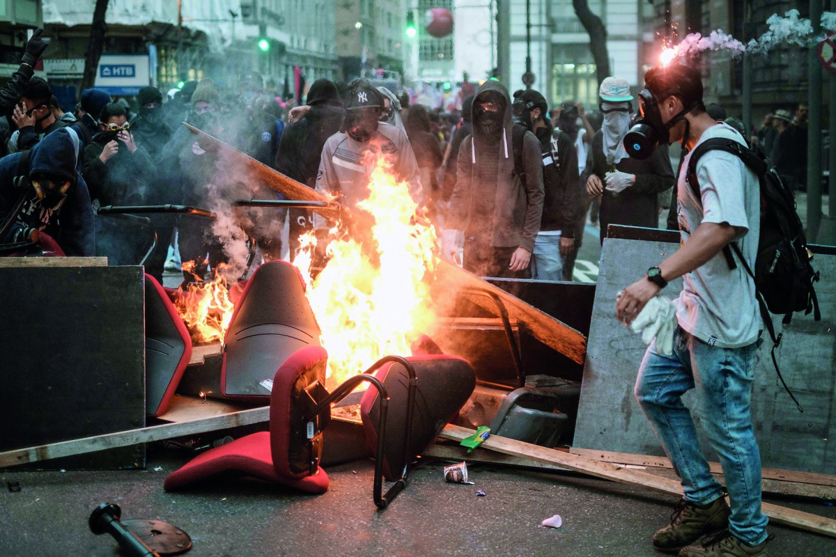Protesters burn items looted from offices during the nationwide strike called by unions opposing austerity reforms in Rio de Janeiro