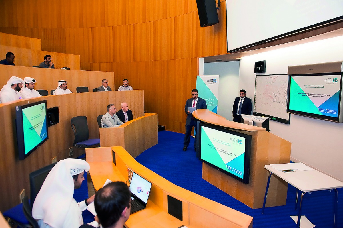 Students from College of Science and Engineering defending  their theses at a program at HBKU.