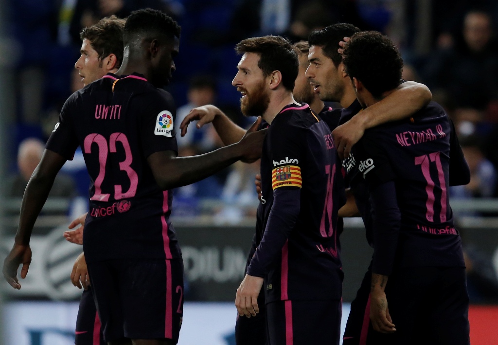 Barcelona's Uruguayan forward Luis Suarez (2ndR) celebrates with Barcelona's Argentinian forward Lionel Messi (C) and teammates after scoring his team's third goal during the Spanish league football match RCD Espanyol vs FC Barcelona at the Cornella-El Pr