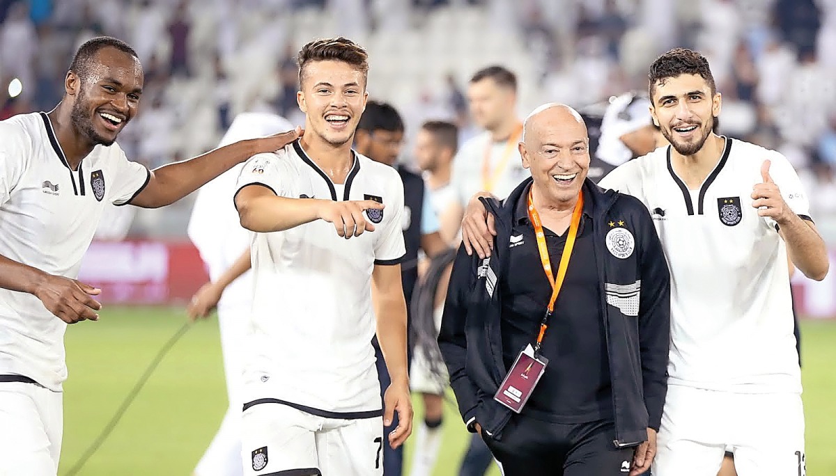 Al Sadd's head coach Jesualdo Ferreira (centre) celebrate along with his players their 2-1 victory over El Jaish in the Qatar Cup final at Al Sadd Stadium on Saturday.