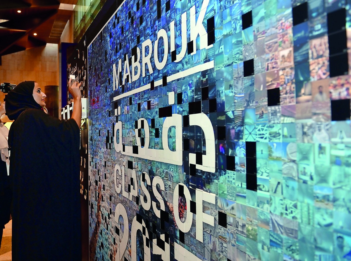 HE Sheikha Hind bint Hamad Al Thani places photos on the HBKU graduation social media mosaic.