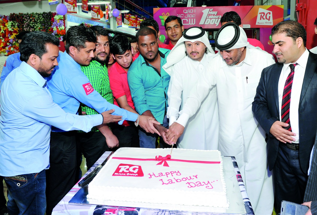  Ramez Group General Manager, Basheer Sayeed with other officials and employees cut a cake to celebrate the International Labour Day at Aswaq Ramez, Abu Hamour.  Pic: Kammutty VP / The Peninsula
