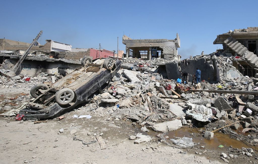 (FILES) This file photo taken on March 26, 2017 shows An Iraqi man amid the rubble of destroyed houses in the Mosul al-Jadida area, following air strikes in which civilians have been reportedly killed during an ongoing offensive against the Islamic State 