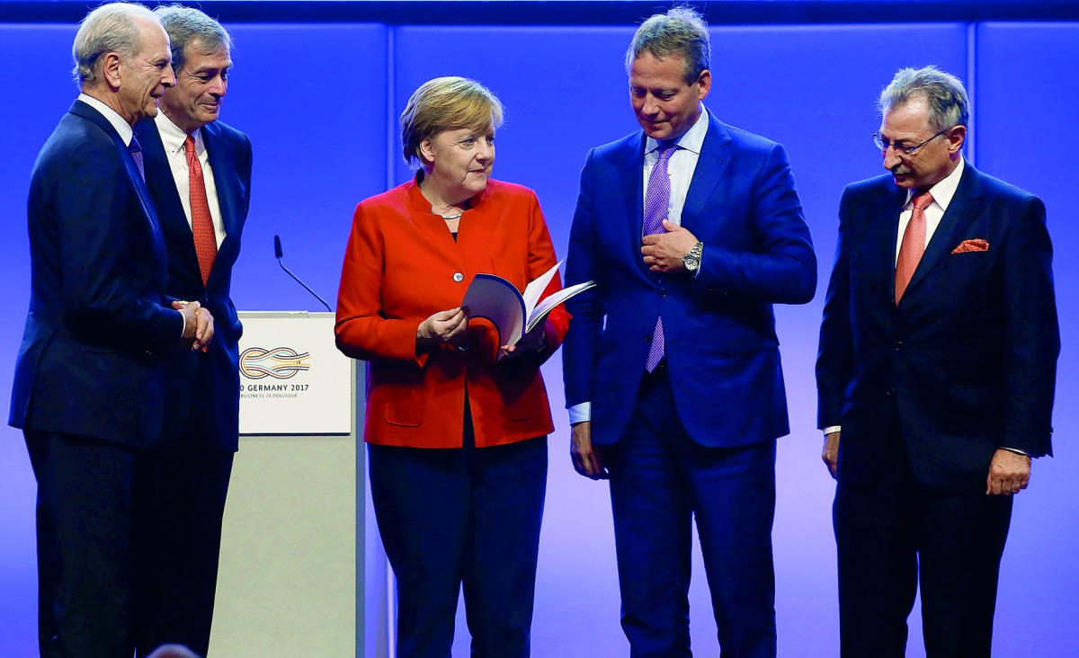 German Chancellor Angela Merkel holds a final declaration of the Business 20 dialogue event with Eric Schweitzer, President of DIHK; Dieter Kempf, Federation of German Industries (BDI); B20 Chairman Juergen Heraeus and Ingo Kramer from Confederation of Ge