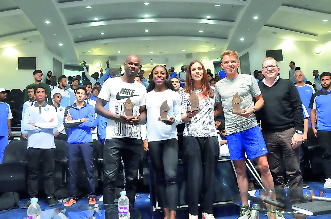 Athletes who are in Doha to compete in tomorrow's Diamond League pose for a group photo along with the coaches and students during their visit to Aspire Dome in Doha yesterday. Qatar Athletics Federation (QAF) and the Diamond League arranged the event.