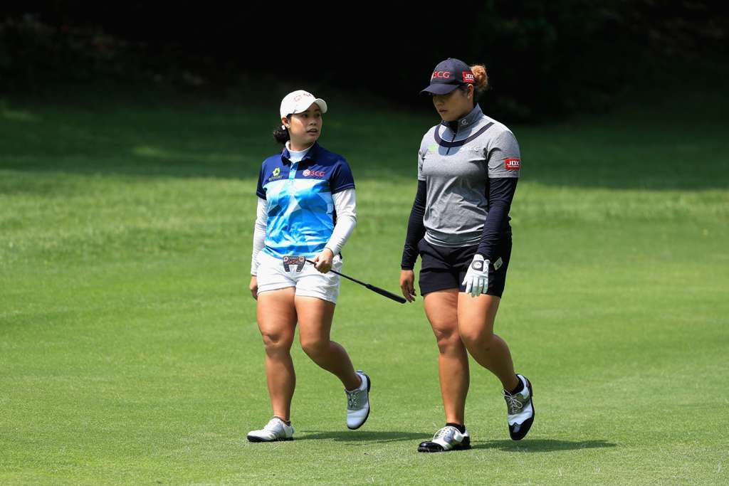(L-R) Sisters Moriya Jutanugarn and Ariya Jutanugarn of Thailand walk towards the twelfth green during the second round of the Citibanamex Lorena Ochoa Match Play Presented by Aeromexico and Delta at Club De Golf Mexico on May 5, 2017 in Mexico City, Mexi
