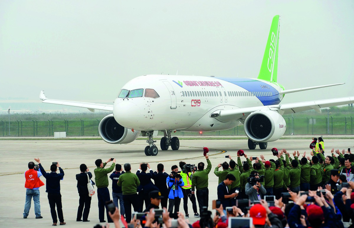 China's home-grown C919 passenger jet returns after completing its maiden flight at Pudong International Airport in Shanghai.