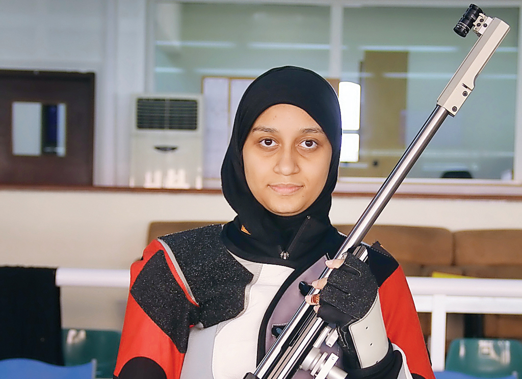 Qatari shooter Aisha Al Suwaidi poses for a photograph with her rifle. The 19-year-old believes reaching the 2020 Olympic Games and competing against the best is a 'realistic' goal.