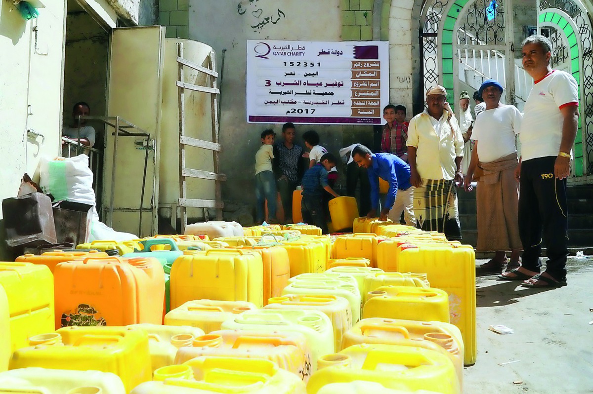 People collect water from a project supported by Qatar Charity in cooperation with Sobol Charity in Yemen's Taiz.