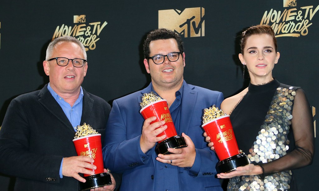 Director Bill Condon (L) stands with actors Josh Gad (C) and Emma Watson (R), winners of Movie of the Year for 'Beauty and the Beast' in the press room during the 2017 MTV Movie & TV Awards at the Shrine Auditorium in Los Angeles, California, May 7, 2017.