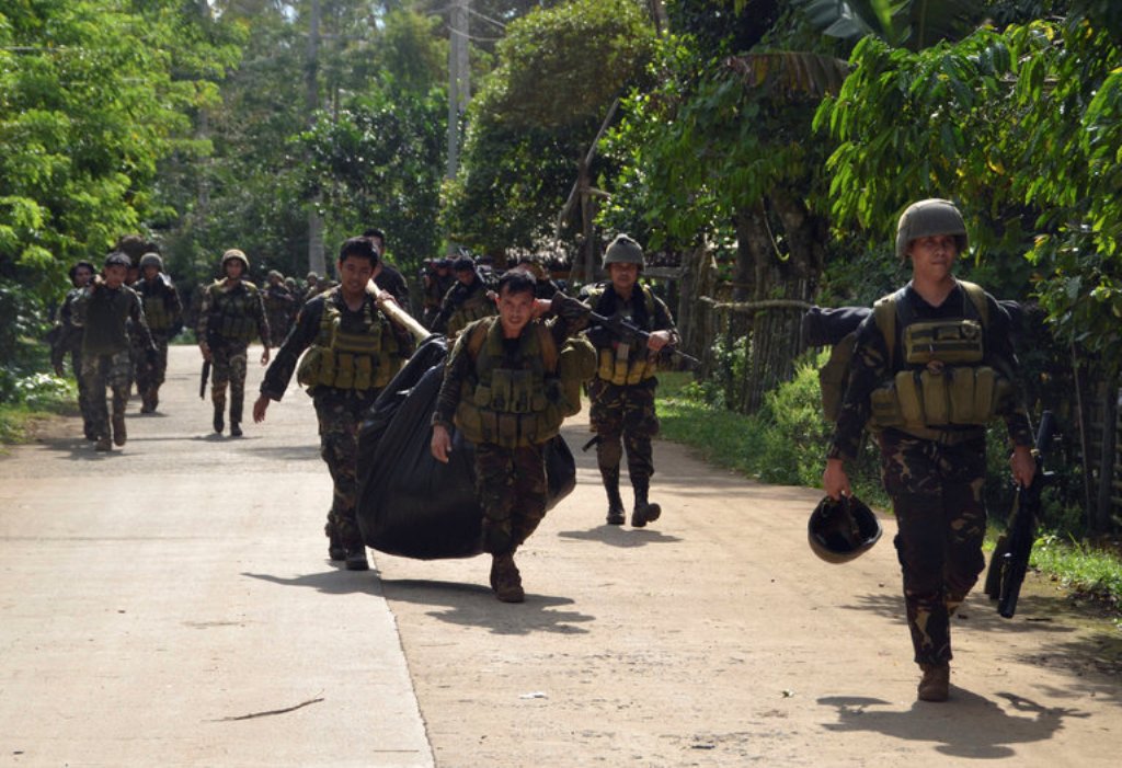File Photo: Troops carrying dead bodies last week after a military operation against Abu Sayyaf in the southern Philippine province of Sulu. Credit Nickee Butlangan/Reuters.