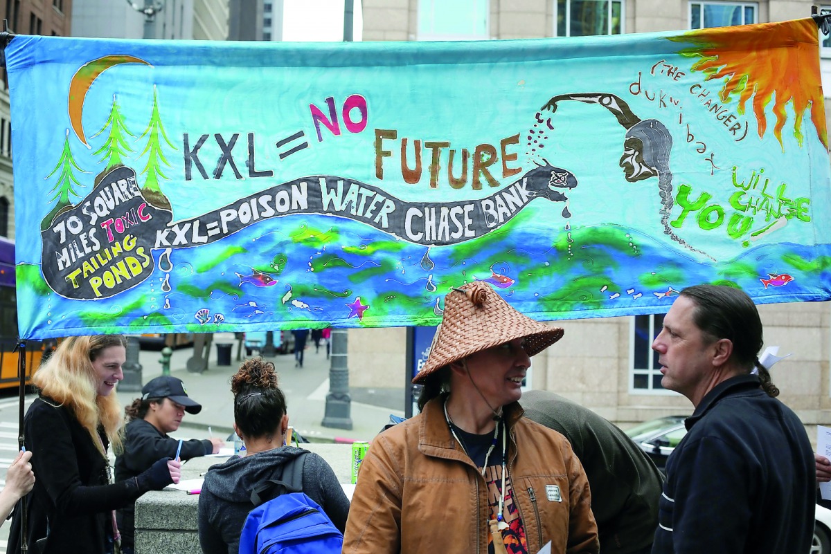 Native American leaders and climate activists prepare to protest outside a Chase Bank location, in opposition to the Keystone XL Pipeline, in Seattle, yesterday.
