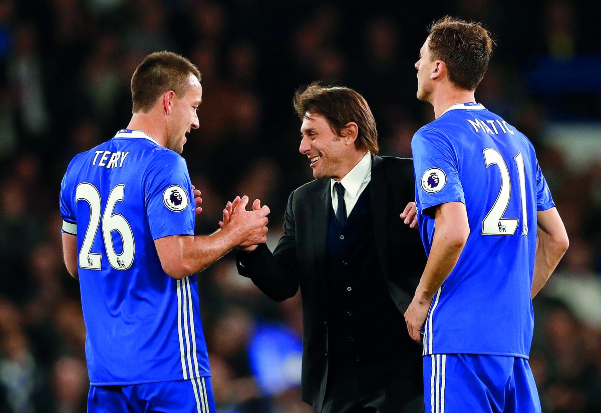 Chelsea manager Antonio Conte celebrates after the English Premier League match against Middlesbrough with John Terry and Nemanja Matic at Stamford Bridge yesterday.
