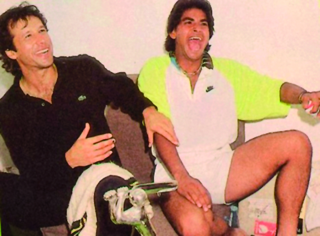 Legendary Pakistani cricketer Imran Khan and team-mate Aqib Javed share a light moment in this file photo.