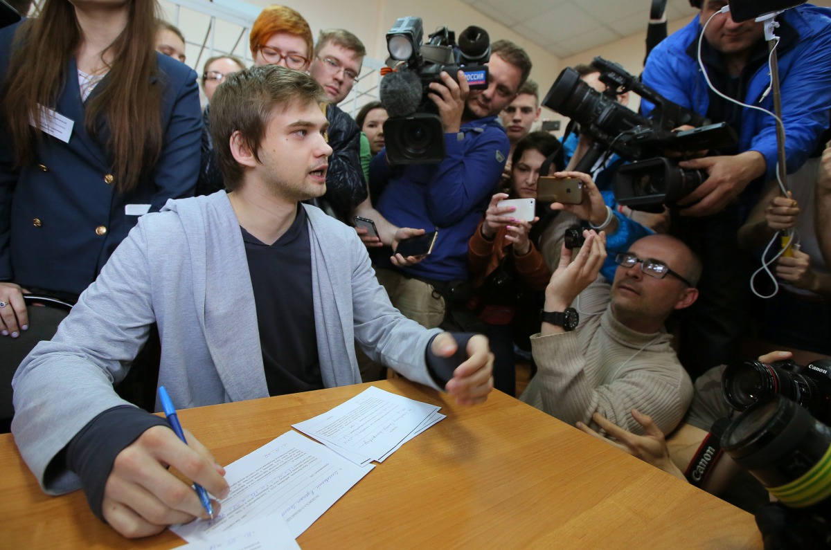 Ruslan Sokolovsky (L), a blogger who played Pokemon Go on his phone in a church, speaks to the press during a hearing at a court in Yekaterinburg on May 11, 2017. A Russian court on May 11 convicted a video blogger of inciting hatred against believers by 