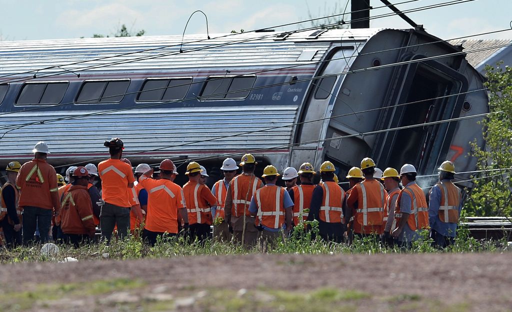(FILES) This file photo taken on May 13, 2015 shows rescuers gathering around a derailed carriage of an Amtrak train in Philadelphia, Pennsylvania. AFP / JEWEL SAMAD
