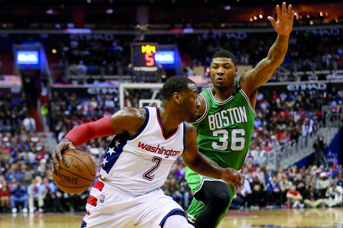 Washington Wizards guard John Wall (left) dribbles the ball as Boston Celtics guard Marcus Smart defends in the third quarter in game six of their second round of the 2017 NBA Play-offs at Verizon Center on Friday.