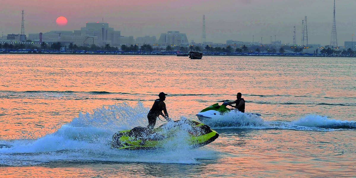 People enjoy the warm weather on jet skis off Doha Corniche yesterday. Pic: Kammutty VP/ The Peninsula
