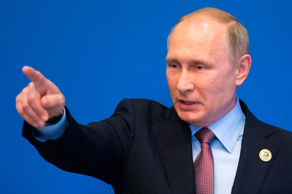 Russian President Vladimir Putin gestures while speaking to the media after the Belt and Road Forum at the China National Convention Center at the Yanqi Lake venue outside Beijing on May 15, 2017. / AFP / POOL / Alexander Zemlianichenko
