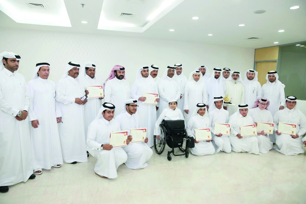 Minister of Education and Higher Education, H E Dr Mohammed bin Abdul Wahid Al Hammadi, with award-winning students and teachers. RIGHT: The Minister  with Ghanim Mohammed Al Muftah, a student at Doha Academy, who is one of the award winners. 