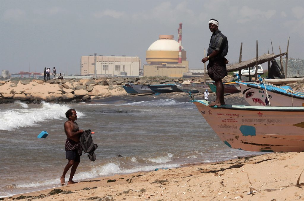 A fisherman stands on his boat on a beach near Kudankulam nuclear power project in the southern Indian state of Tamil Nadu September 13, 2012. REUTERS/Adnan Abidi
