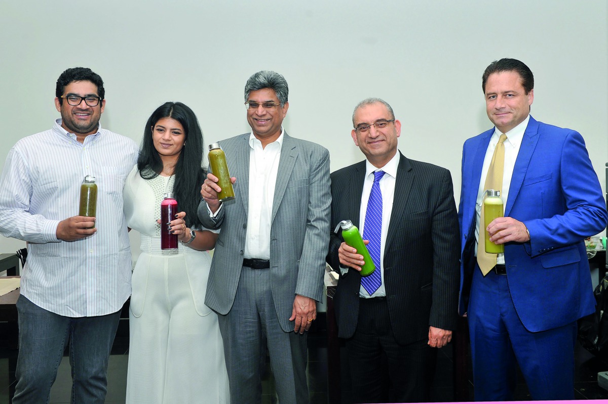 Chief Executive Officer of AlMana Group, Srinivas Vemparala (Centre), and other officials at the launch of Juicin’ It at Palm city Gardens. (Pic: Kammutty VP/ The Peninsula)