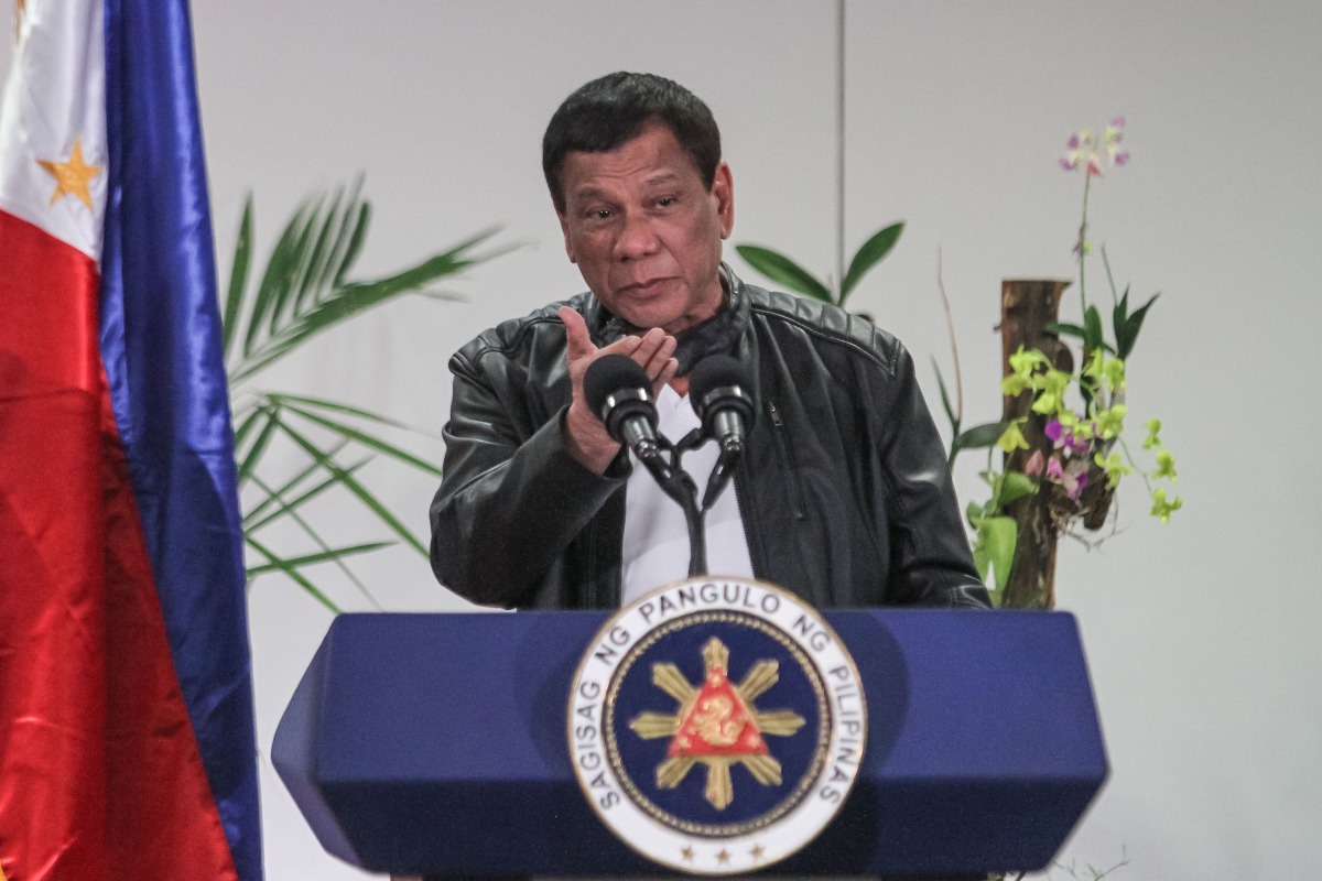 Philippine President Rodrigo Duterte gestures as he speaks shortly after arriving in Davao on May 16, 2017, from a working visit to China.   AFP / MANMAN DEJETO
