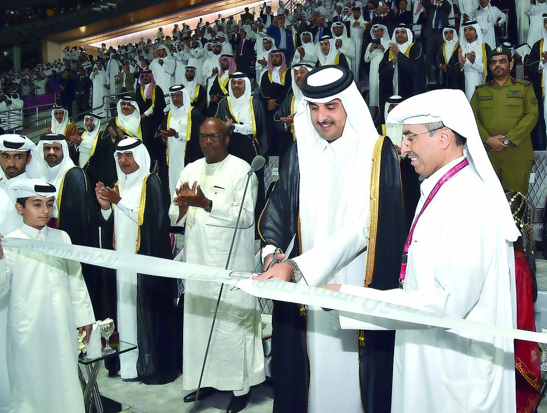 Emir H H Sheikh Tamim bin Hamad Al Thani cutting the ribbon to officially announce the inauguration of the refurbished Khalifa International Stadium, yesterday.