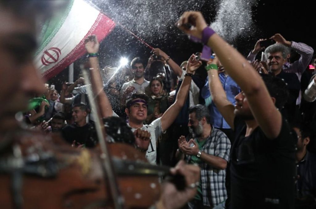 Supporters of newly re-elected Iranian President Hassan Rouhani dance during a gathering to celebrate his victory at the Vanak square in downtown Tehran on May 20, 2017 (AFP Photo/Behrouz MEHRI).