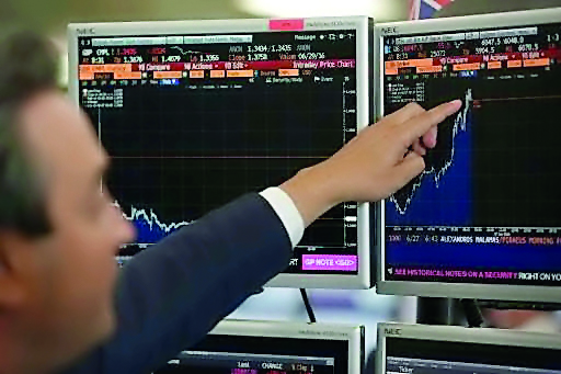 A  stock broker reading the market trend at the Bloomberg terminal in this photo.   The rise of the Symphony system has been portrayed as a threat to the Bloomberg terminal's dominance in trading rooms.