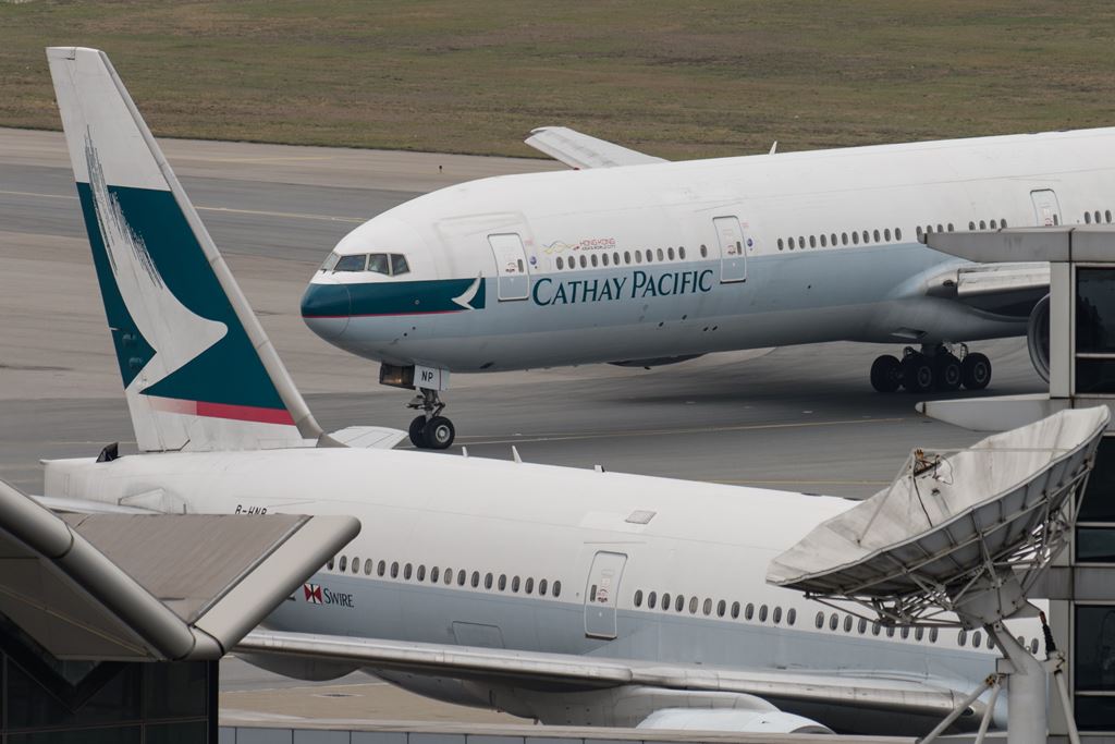 (FILES) In this file photo taken on March 15, 2017 a Cathay Pacific Boeing 777 passenger aircraft (top) taxis past a stationary plane on the tarmac at the international airport in Hong Kong. AFP / Anthony WALLACE
