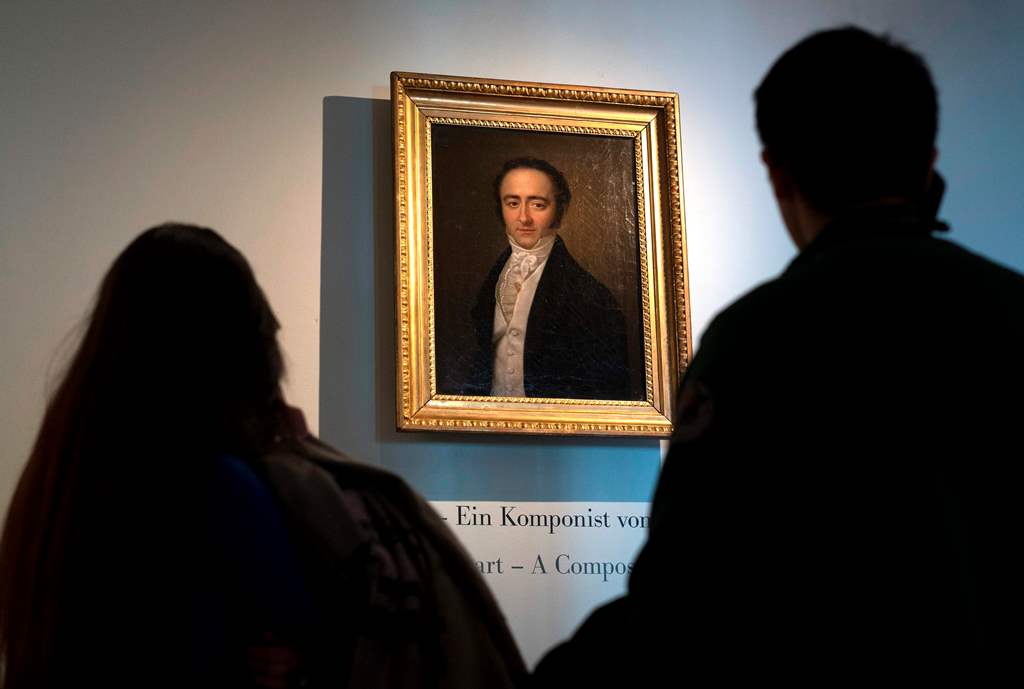 Visitors look at a painting of the Austrian musician Franz Xaver Mozart (son of Wolfgang Amadeus Mozart) at the Mozart Residence in Salzburg, as part of an exhibition organised by the Mozarteum Foundation, on March 09, 2016. / AFP / JOE KLAMAR