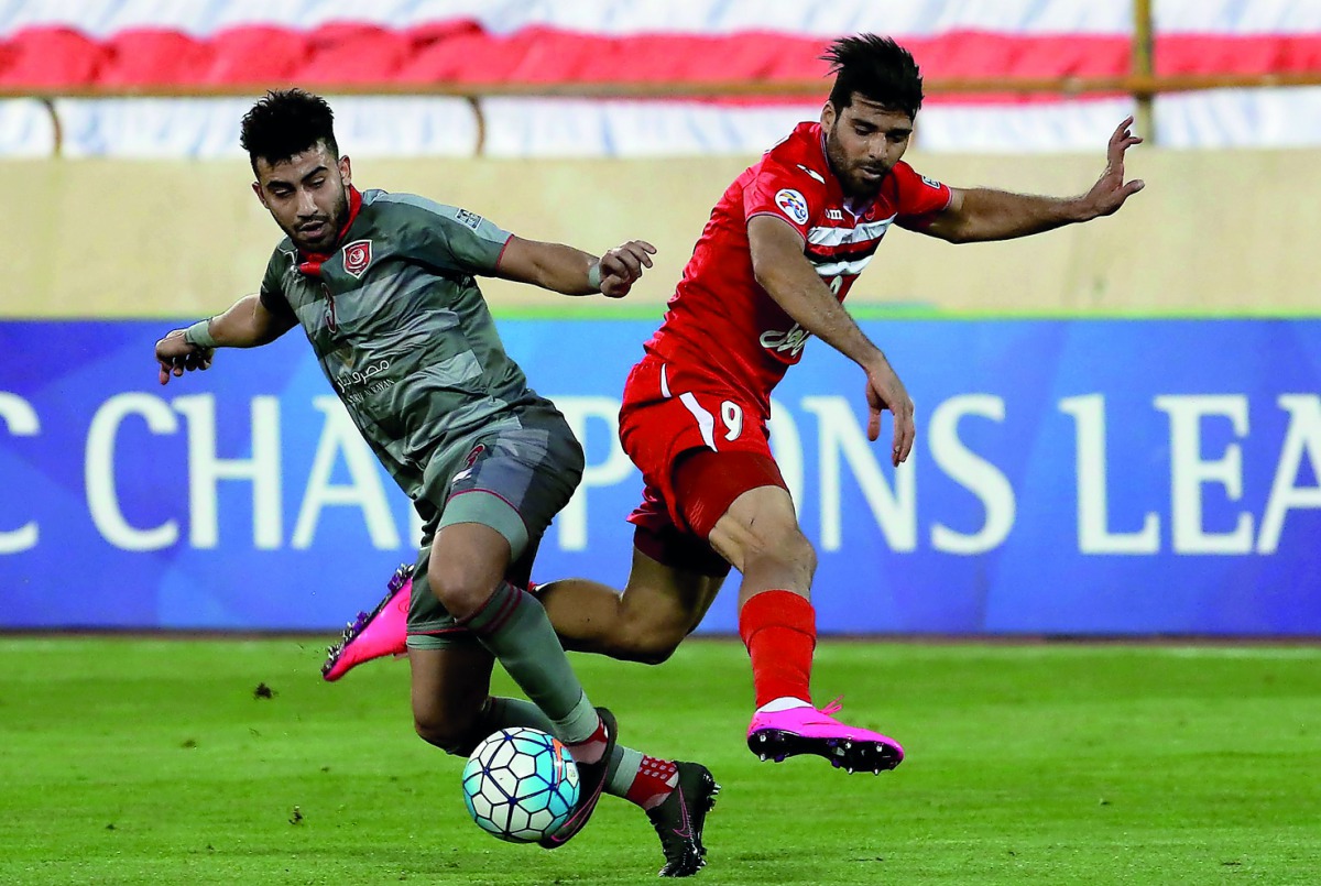 Lekhwiya's Ahmed Yasser (left) vies for the ball possession against Persepolis' Mehdi Taremi during their AFC Champions League  match played at the Azadi Stadium in Tehran yesterday.