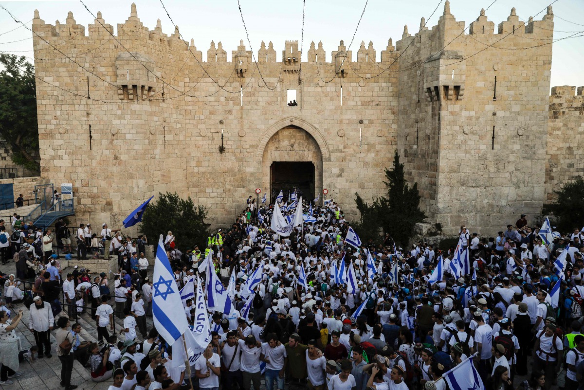 Far right Israeli supporters wave Israeli flags as they pass through the Damascus Gate in Jerusalem's Old City on May 24, 2017 to commemorate the Jerusalem Day, marking the establishment of Israeli control over the Old City following its capture in the Si