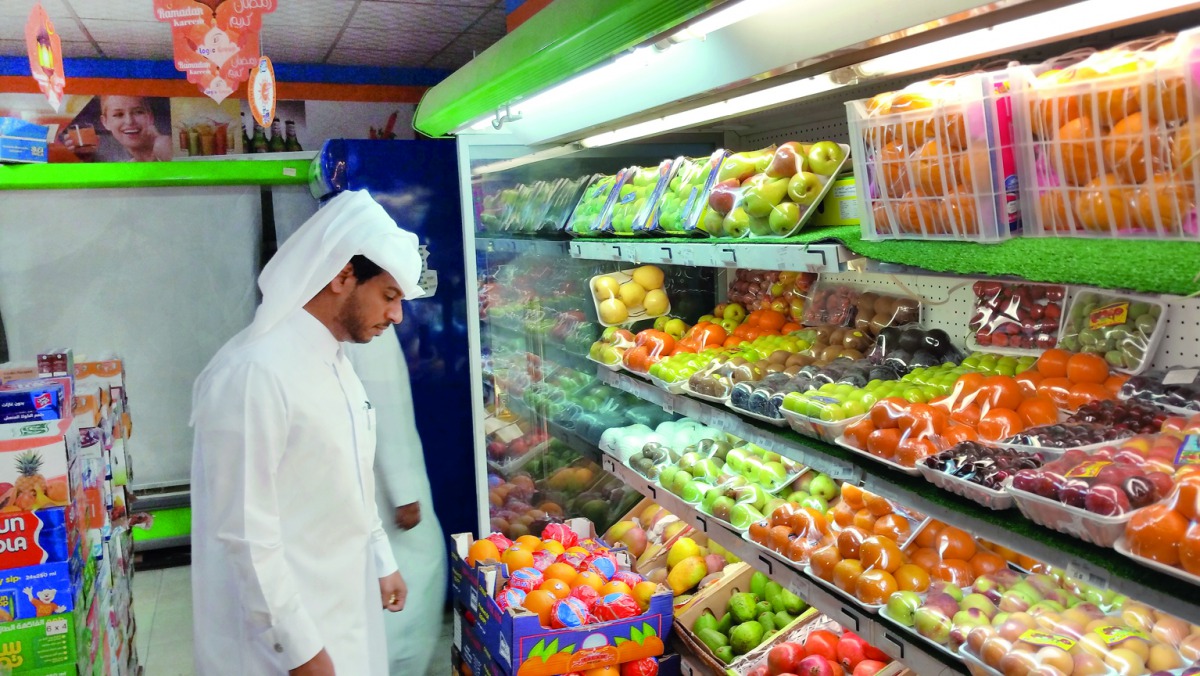 A municipal official inspecting fruits at an outlet. 