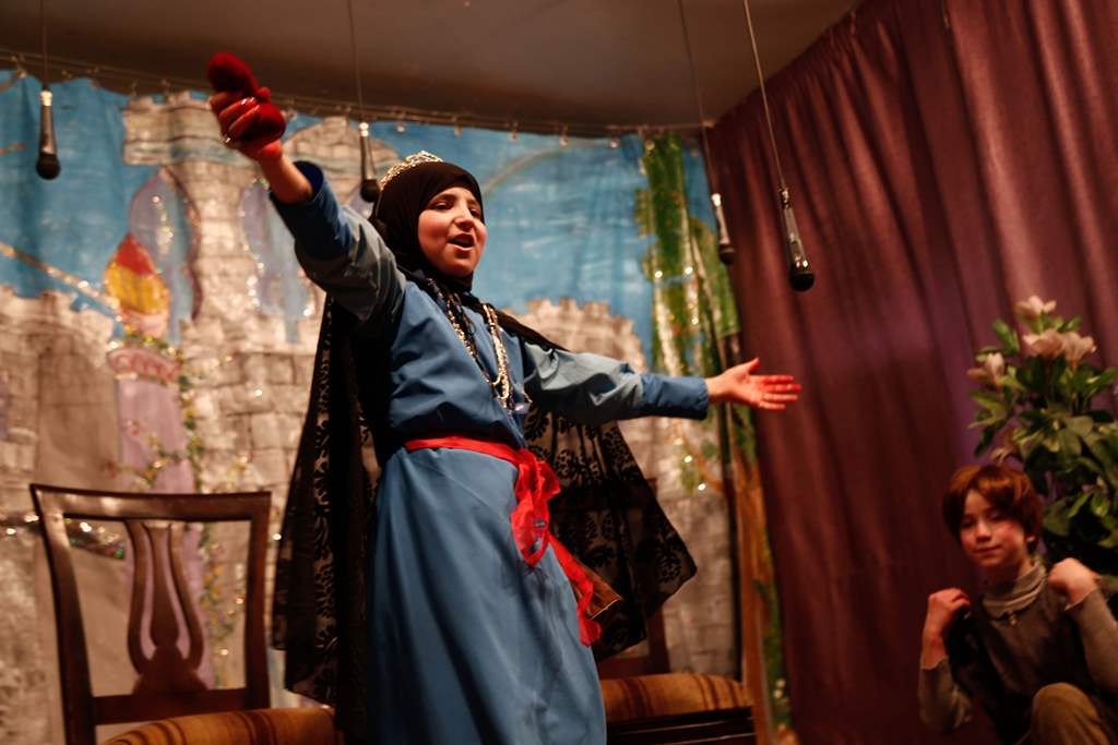 Syrian girls act in an English-language school-play adaptation of Snow White and the Seven Dwarfs at a local school in the rebel-held town of Douma, on the eastern outskirts of Damascus, on May 23, 2017. AFP / Abdullah HAMMAM
