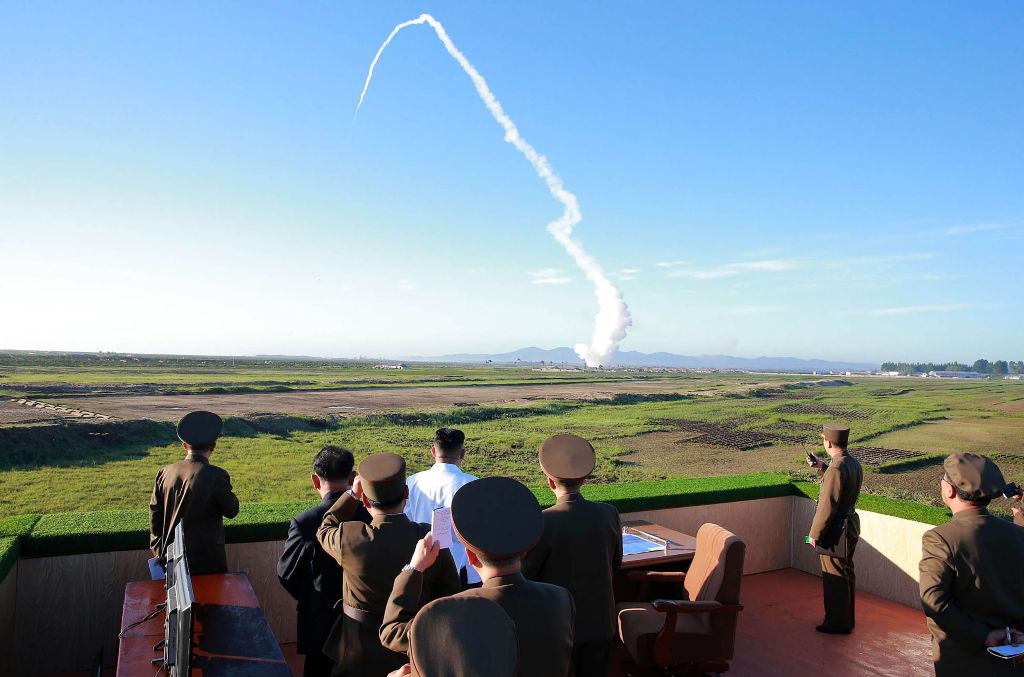 This undated picture released from North Korea's official Korean Central News Agency (KCNA) on May 28, 2017 shows North Korean leader Kim Jong-Un (C-in white shirt) watching the test of a new anti-aircraft guided weapon system organized by the Academy of 