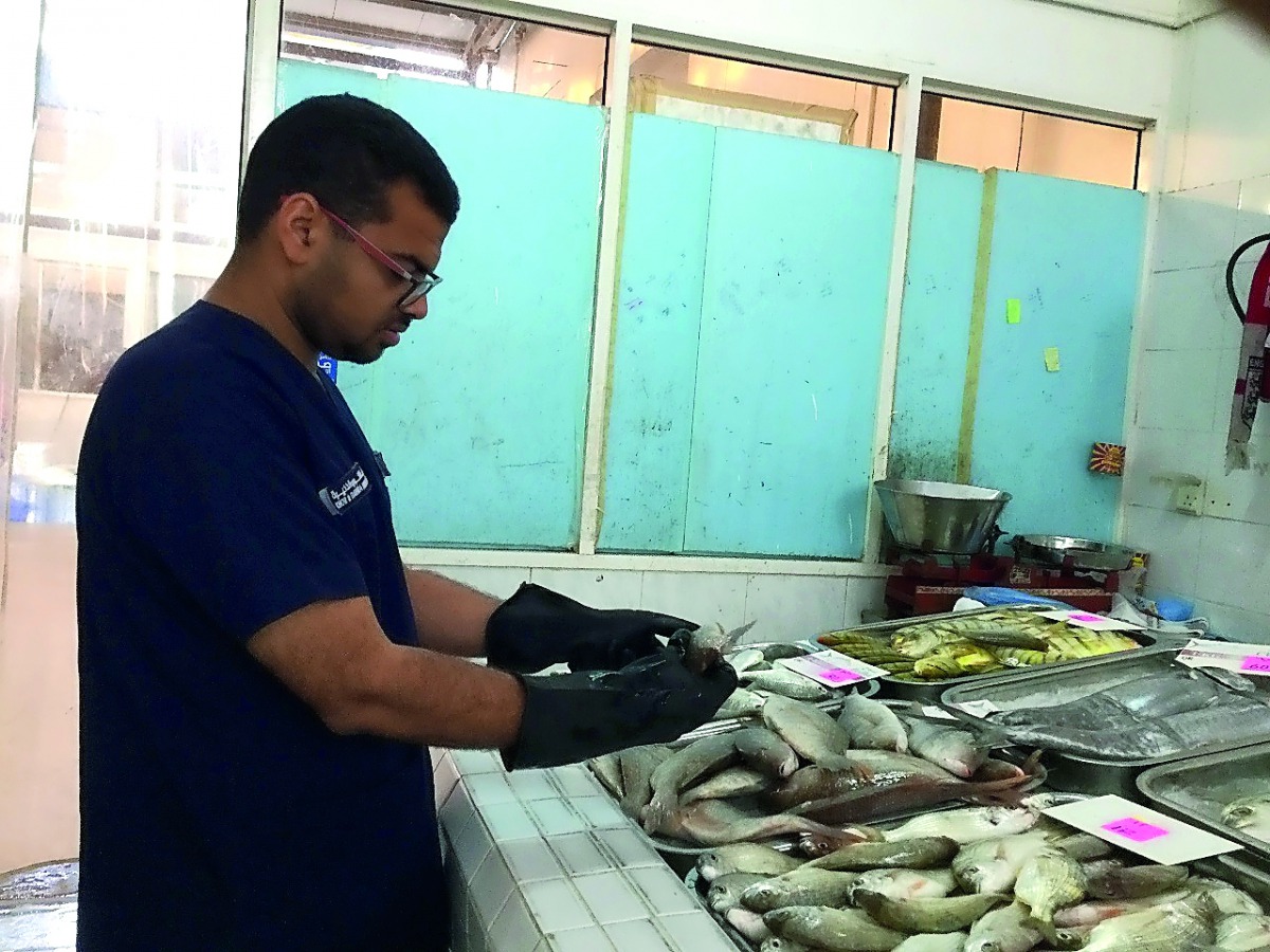 An inspector checking a fish-selling outlet, where 150kg  of fish unfit for consumption has been destroyed.