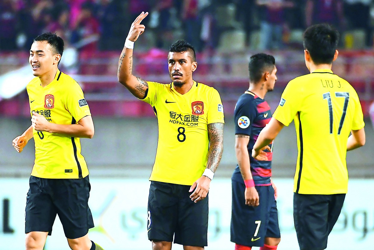 Guangzhou Evergrande's midfielder Paulinho celebrates his goal during the AFC Champions League match against Kashima Antlers in Kashima, Ibaraki prefecture yesterday. 