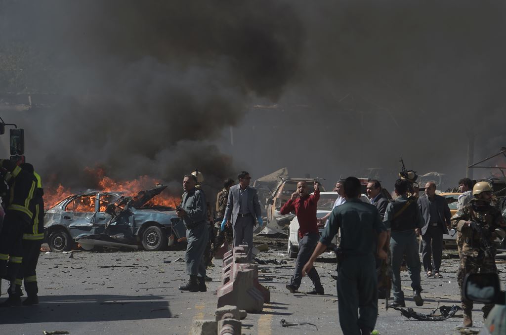 Afghan security forces personnel are seen at the site of a car bomb attack in Kabul on May 31, 2017. At least 40 people were killed or wounded on May 31 as a massive blast ripped through Kabul's diplomatic quarter, shattering the morning rush hour and bri