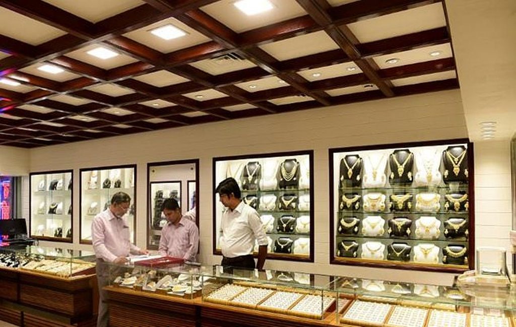 This picture taken on May 24, 2017 shows salesmen waiting for customers at a gold jewelry shop in Dhaka
