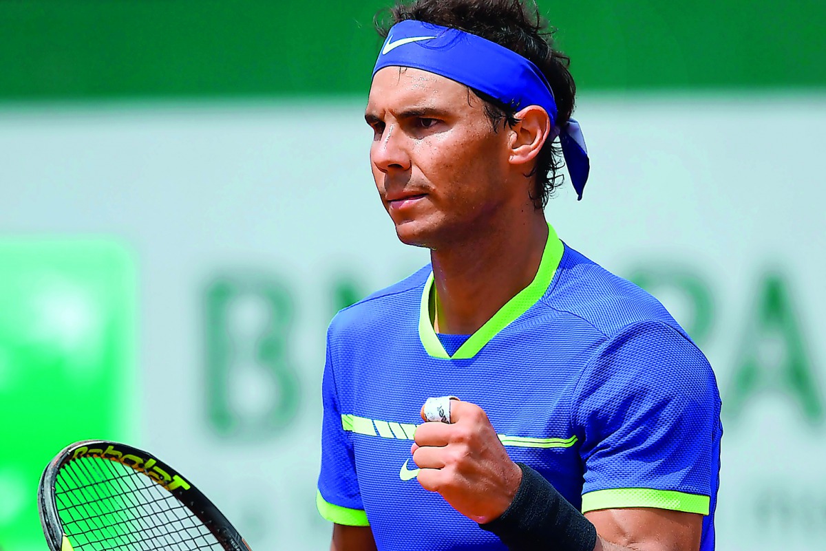 Spain's Rafael Nadal celebrates after winning his match against Spain's Roberto Bautista Agut at the French Open in Paris, yesterday.