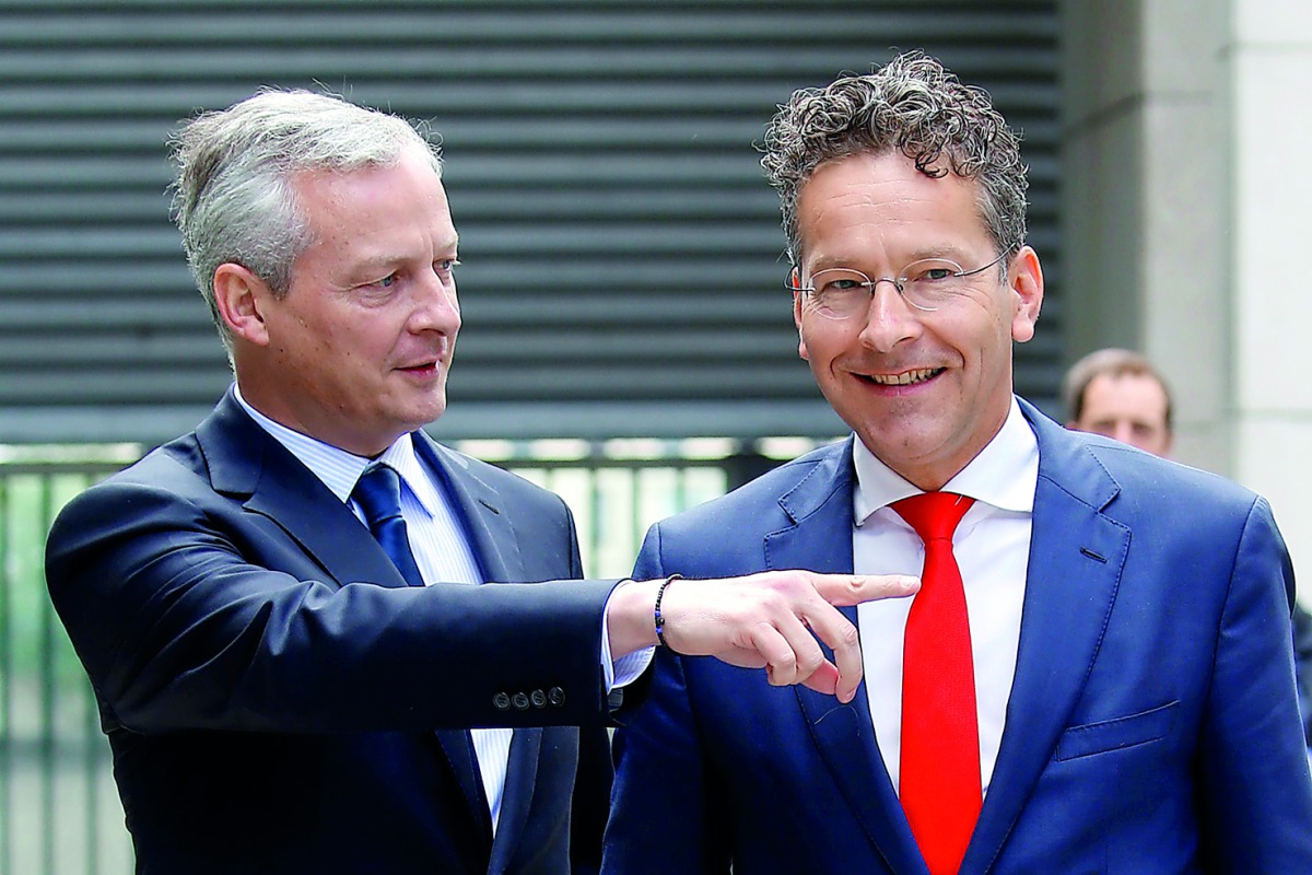 Dutch Finance Minister and Eurogroup President Jeroen Dijsselbloem (right) is greeted by French Economy Minister Bruno Le Maire upon his arrival at the Bercy Finance Ministry in Paris, France, yesterday.