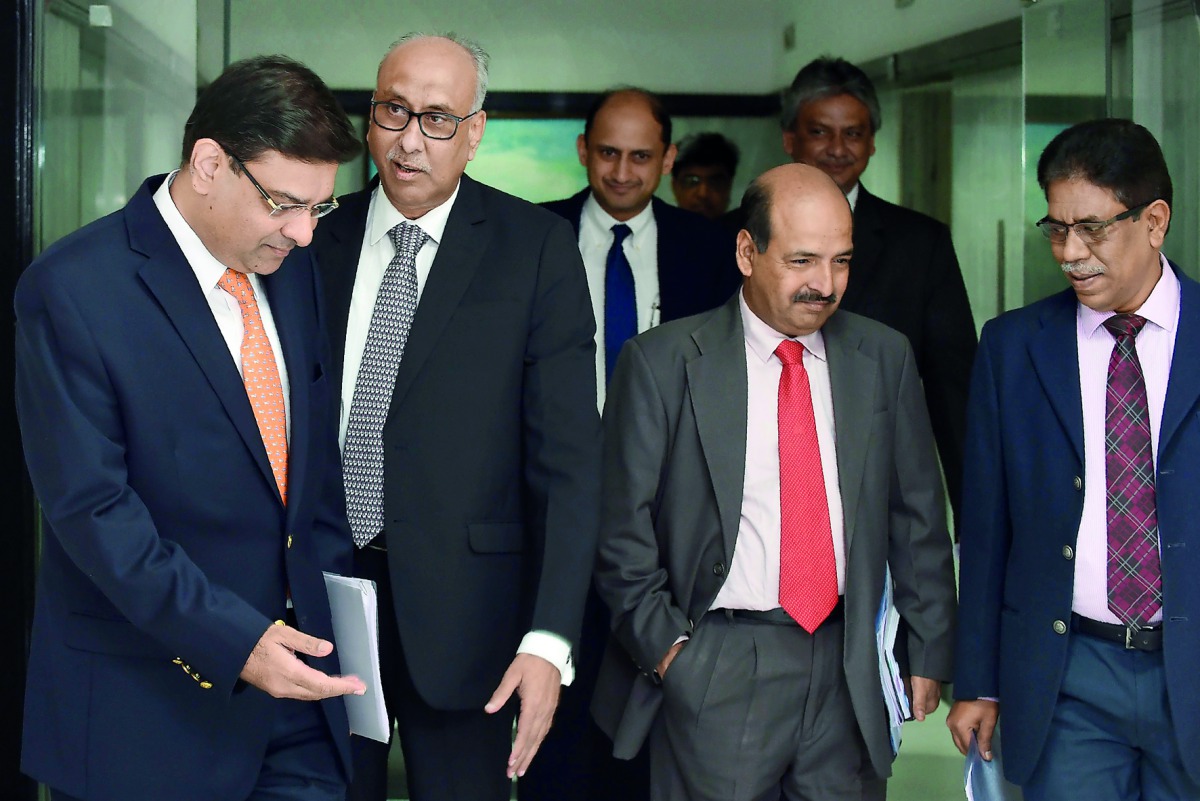 RBI governor Urjit Patel (left) arrives ahead of a press conference at the RBI headquarters in Mumbai, yesterday.