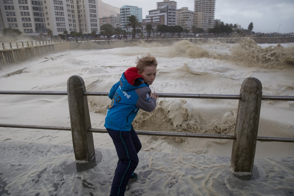 CAPE TOWN, SOUTH AFRICA: A kid stands over the bridge as the huge waves hit coastline during the heavy storm in Cape Town, South Africa on June 7, 2017. (Ashraf Hendricks - Anadolu Agency)