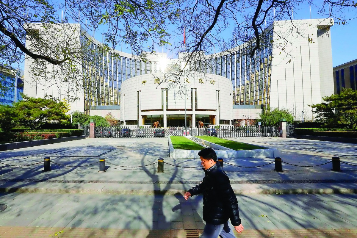 A man walks past the headquarters of the People’s Bank of China (PBOC), the central bank, in Beijing.