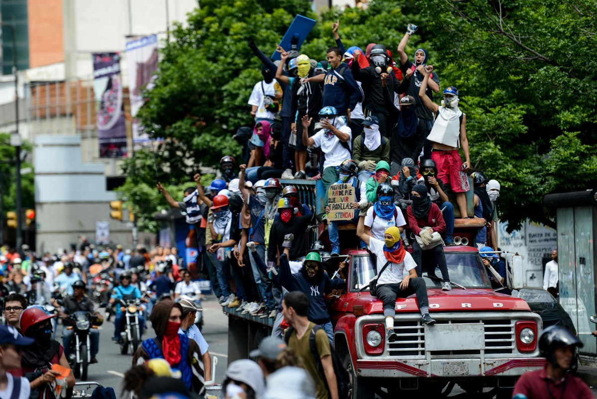 Venezuelan students and other opposition demonstrators protest outside the National Telecommunications Commission (CONATEL) to demand an end to media censorship in the country, in Caracas on June 9, 2017. Clashes at daily protests by demonstrators calling